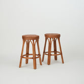 Two Leila Rattan Bar Stools in natural finish, with handwoven seats